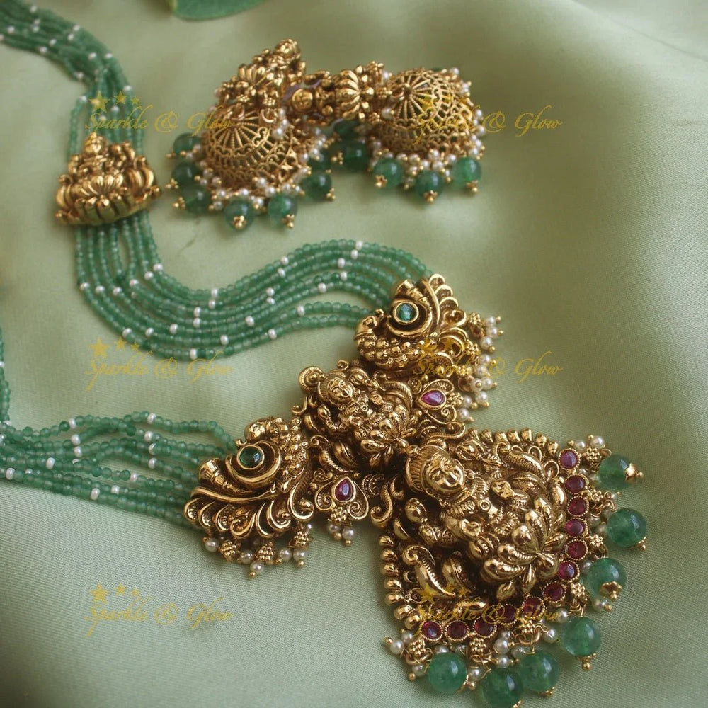 Gorgeous Lakshmi peacock carved pendant haram with multi layer mint green beads chain ruby stones and pearls - Sparkle and Glow