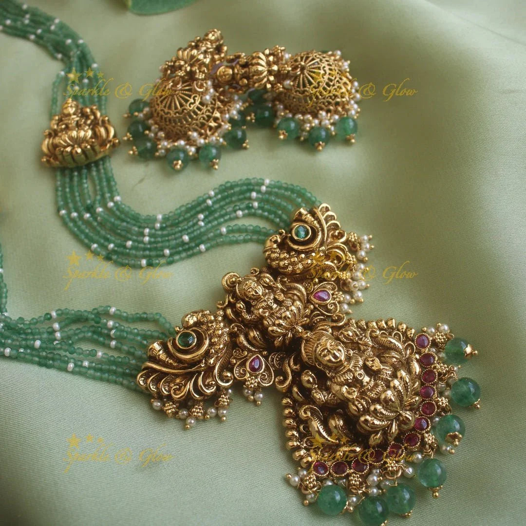 Gorgeous Lakshmi peacock carved pendant haram with multi layer mint green beads chain ruby stones and pearls - Sparkle and Glow