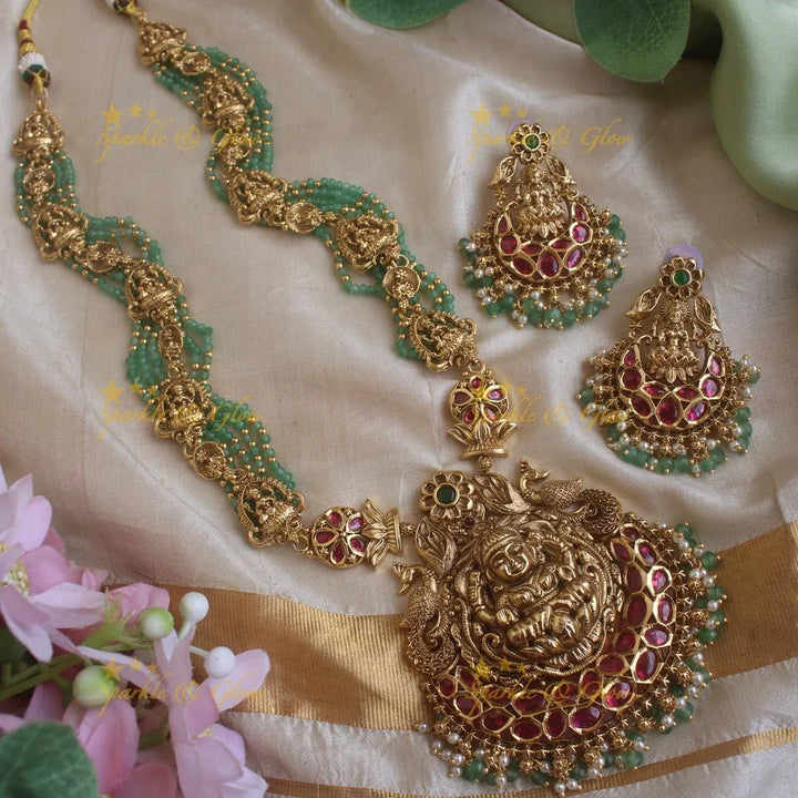 Gorgeous Lakshmi peacock and floral design haram with multi layer gold and mint green beads chain and ruby stones - Sparkle and Glow