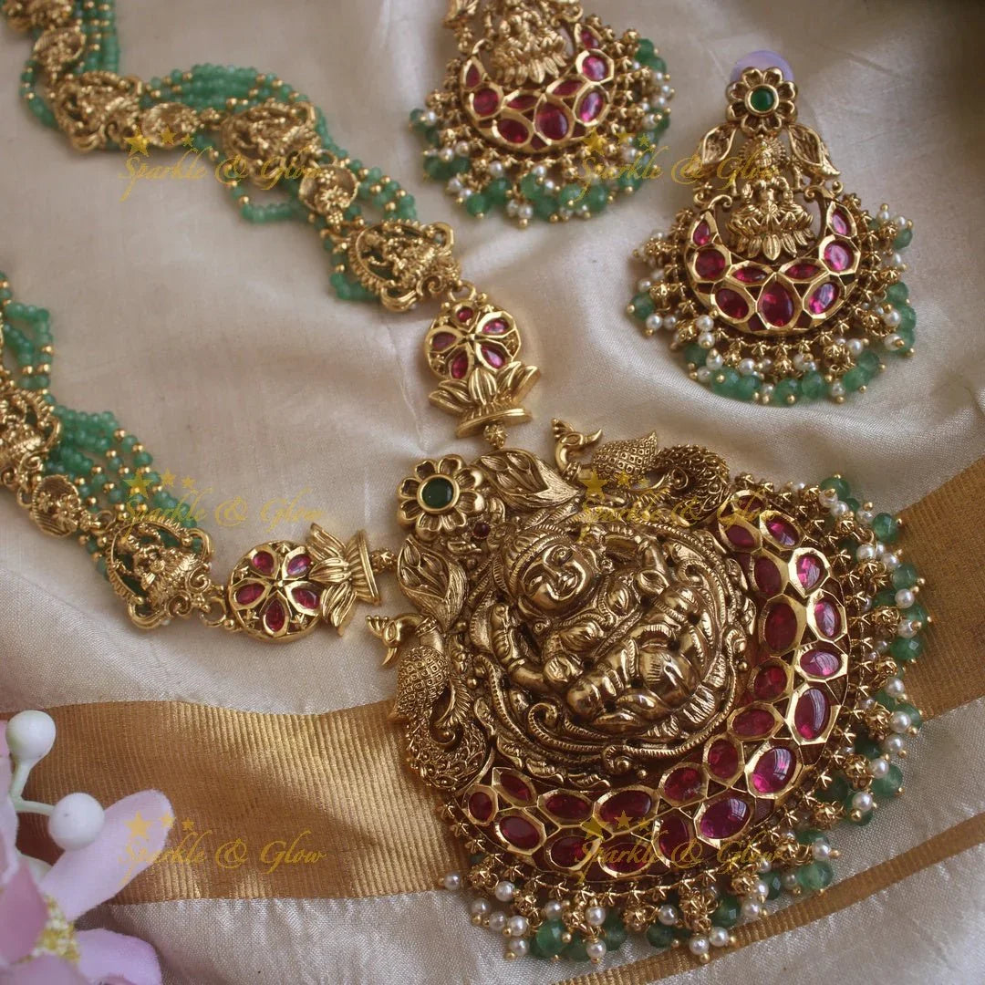 Gorgeous Lakshmi peacock and floral design haram with multi layer gold and mint green beads chain and ruby stones - Sparkle and Glow