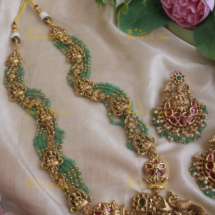 Gorgeous Lakshmi peacock and floral design haram with multi layer gold and mint green beads chain and ruby stones - Sparkle and Glow