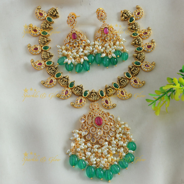 Elegant Lakshmi mango design AD short necklace with ruby emerald rice pearls and green beads
