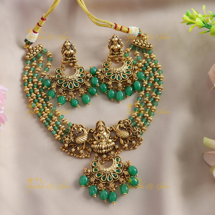Stunning Lakshmi Peacock carved choker with multi layer gold and mint green beads