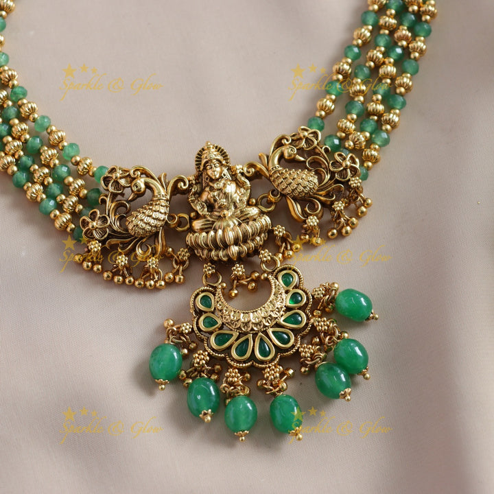 Stunning Lakshmi Peacock carved choker with multi layer gold and mint green beads