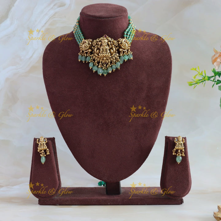 Beautiful Lakshmi Peacock carved choker with multi layer gold and mint green beads