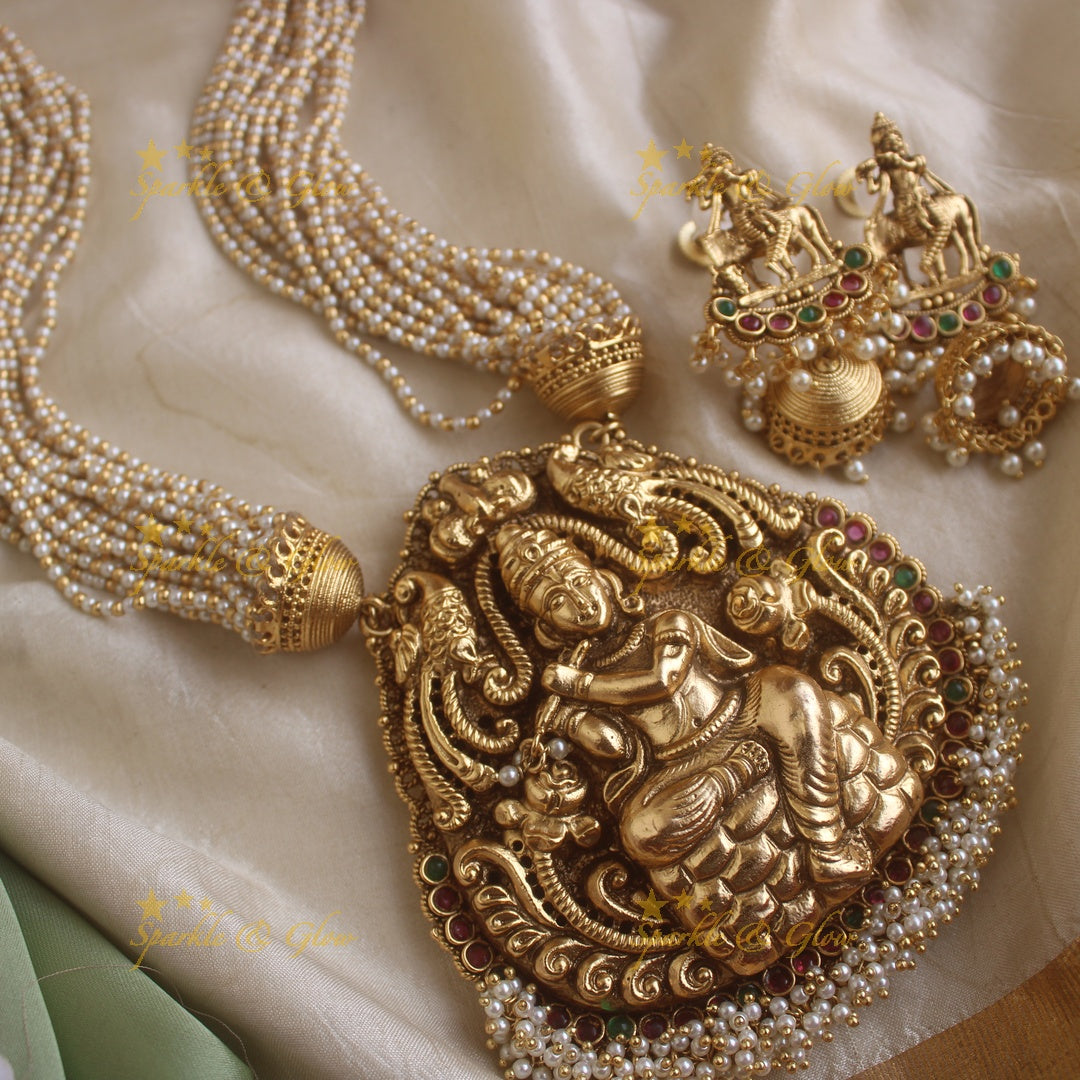 Statement Krishna playing flute and peacock carved haram with multi layer gold and pearl chain