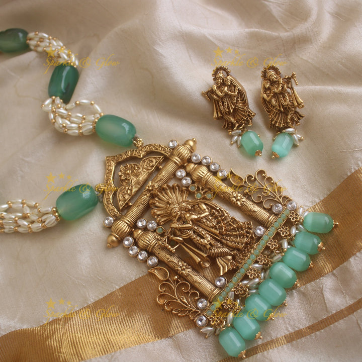 Grand Radha Krishna carved pendant haram with multi layer pearl and mint green beads chain