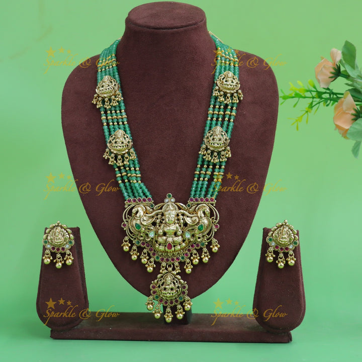 Gorgeous Lakshmi peacock carved pendant haram with multi layer gold and mint green beads