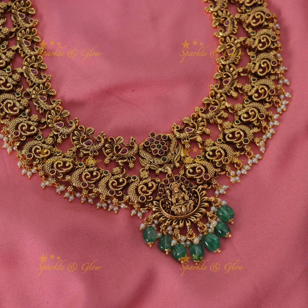 Grand intricate Lakshmi peacock carved long necklace with ruby emerald pearls and green beads - Sparkle and Glow