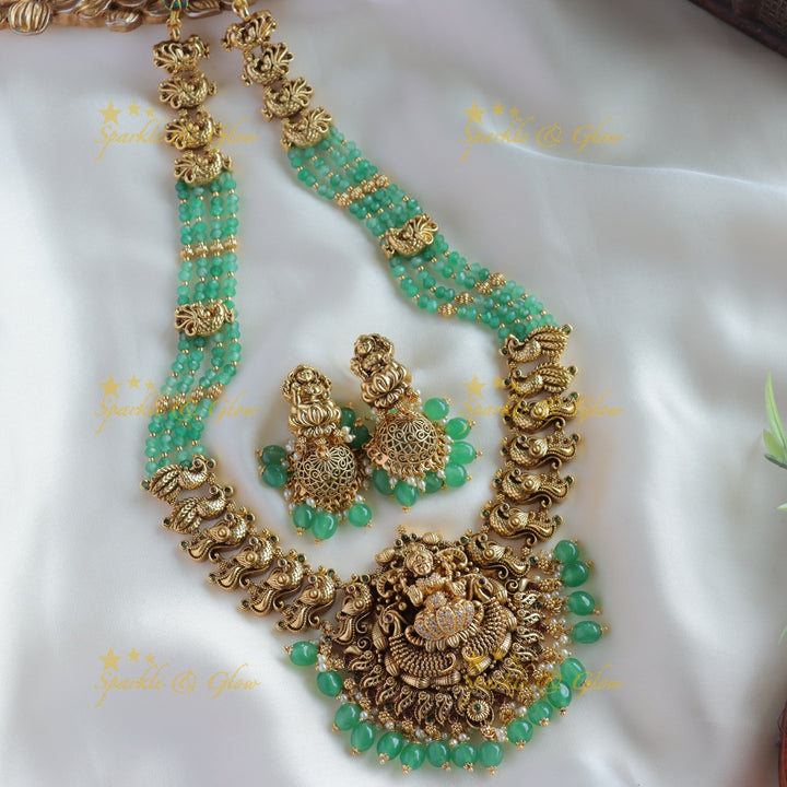 Exclusive Lakshmi peacock carved haram with ruby emerald and multi layer mint green beads chain