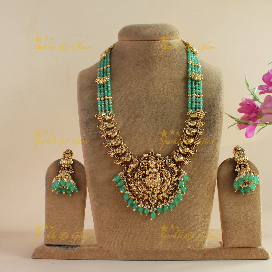 Exclusive Lakshmi peacock carved haram with ruby emerald and multi layer mint green beads chain