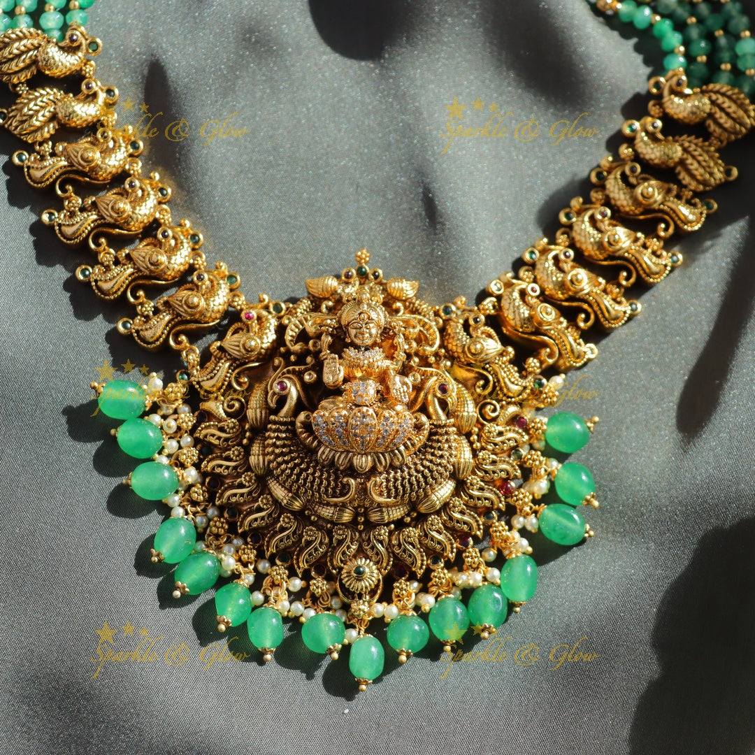 Exclusive Lakshmi peacock carved haram with ruby emerald and multi layer mint green beads chain