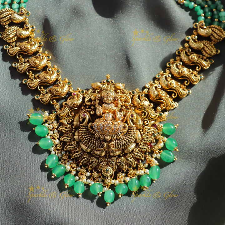 Exclusive Lakshmi peacock carved haram with ruby emerald and multi layer mint green beads chain