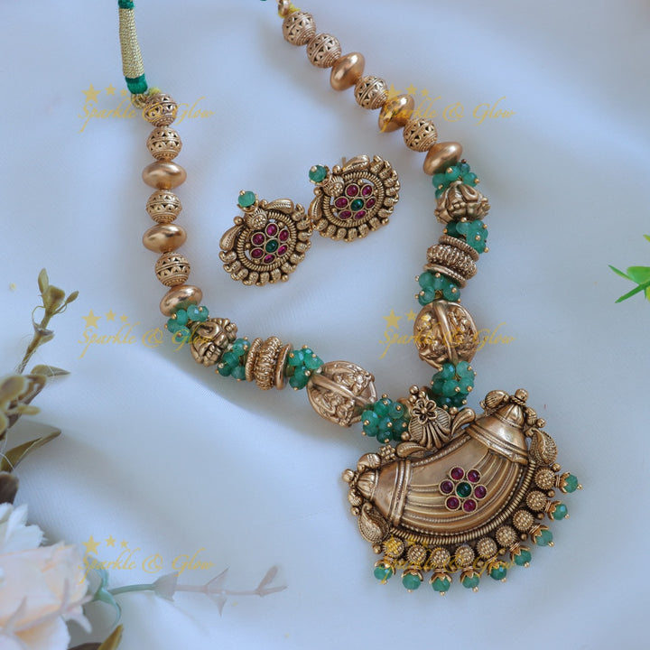 Intricately carved Gold ball beaded floral pendant short necklace with green beads