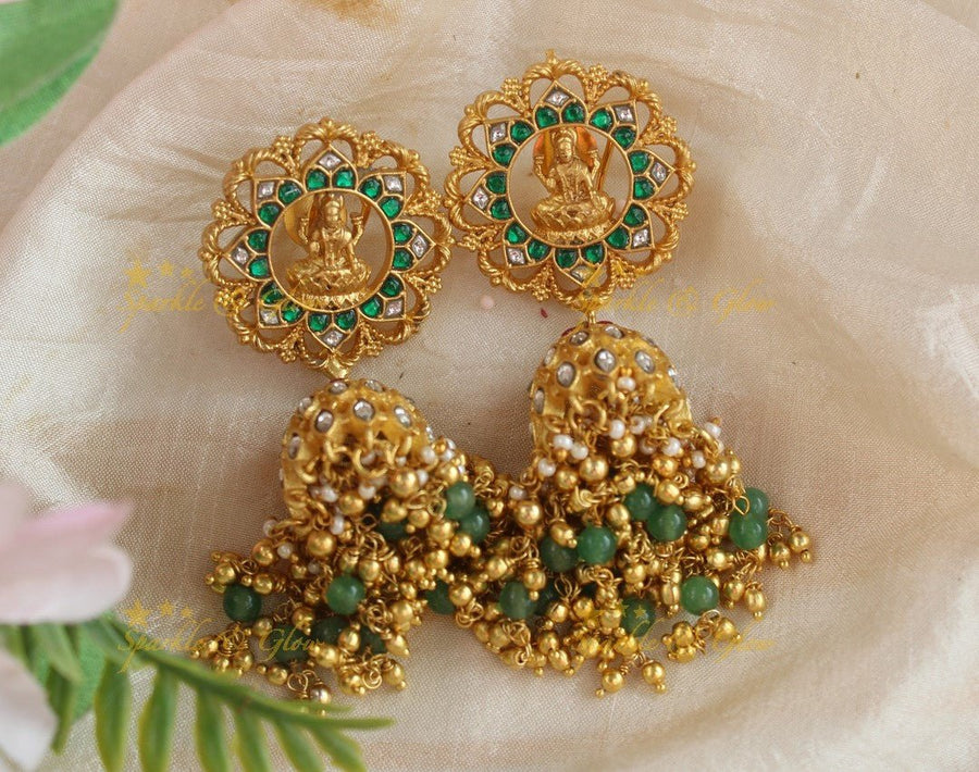 Gracious Idol Lakshmi Floral carved Jadau jhumukas with green and gold beads - Sparkle and Glow - 