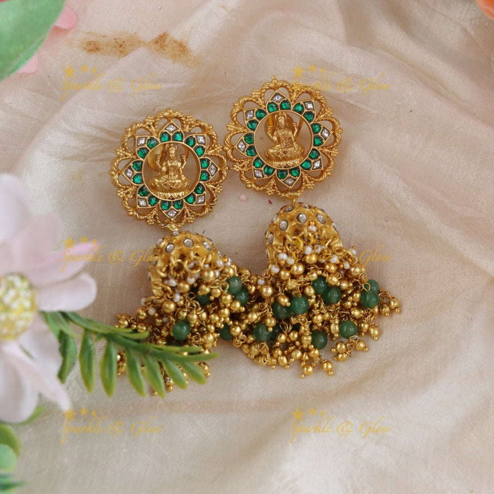Gracious Idol Lakshmi Floral carved Jadau jhumukas with green and gold beads - Sparkle and Glow - 
