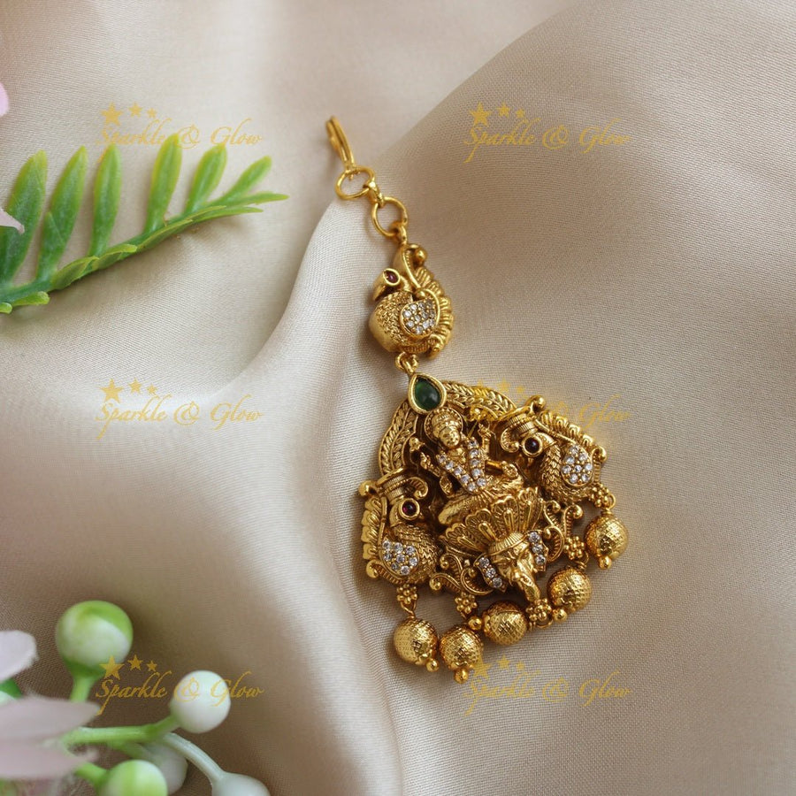 Statement Idol Lakshmi Peacock carved maangtikka with AD stones - Sparkle and Glow - 