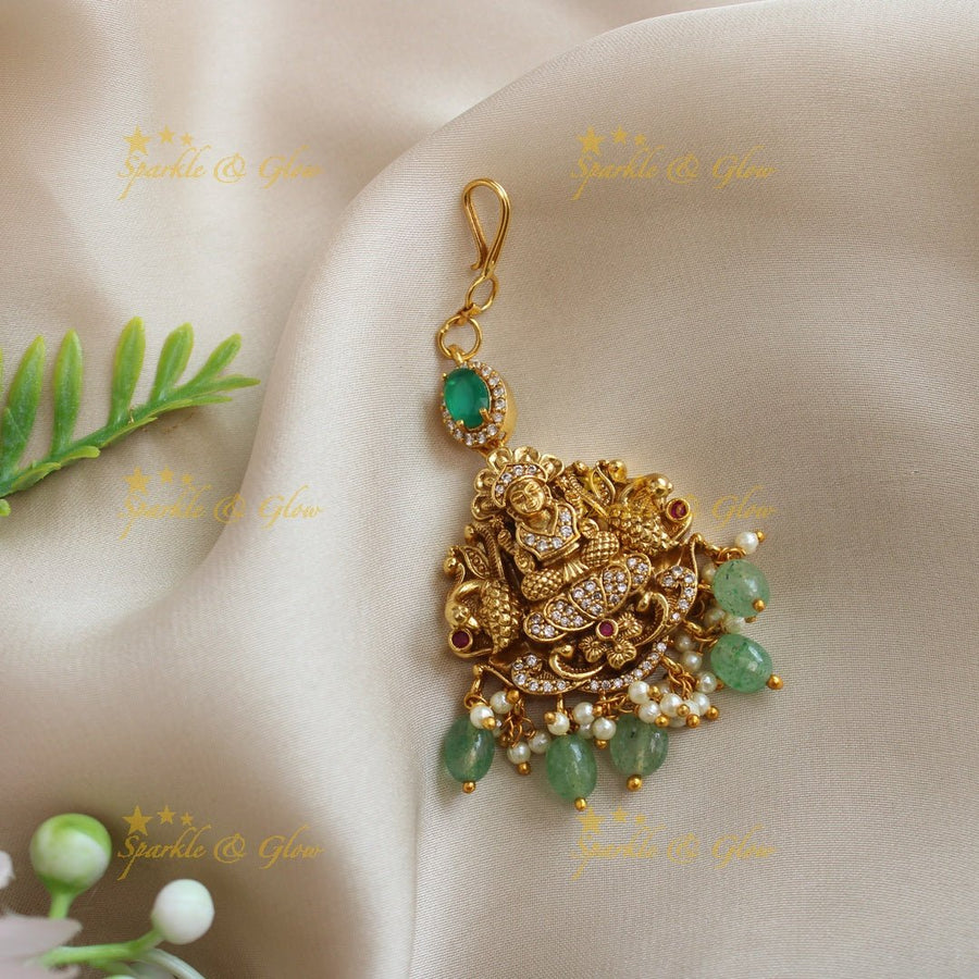 Idol Lakshmi Peacock carved maangtikka with mintgreen beads - Sparkle and Glow - 