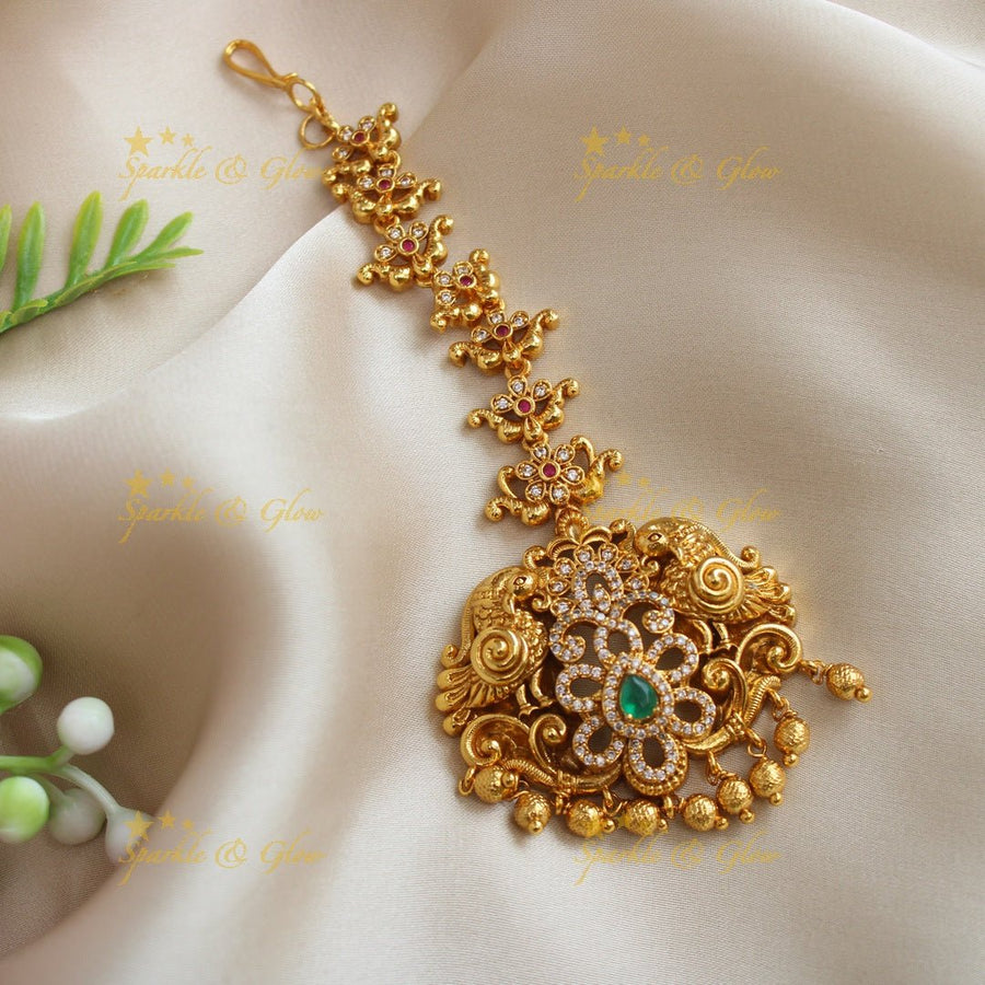 Elegant Dual tone Peacock Floral carved maangtikka with AD stones - Sparkle and Glow - 