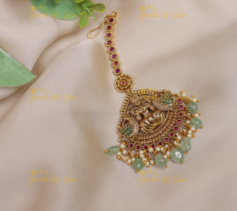 Gracious Idol Lakshmi Peacock Floral carved maangtikka with mintgreen beads - Sparkle and Glow - 