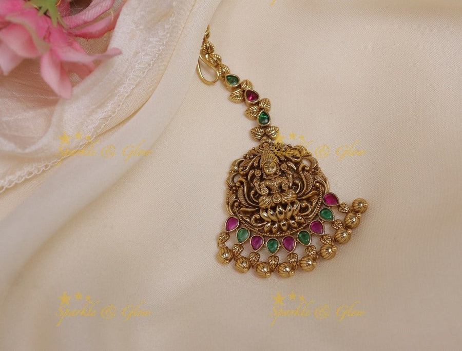 Sparkling Idol Lakshmi carved single line maangtikka with gold beads - Sparkle and Glow - 