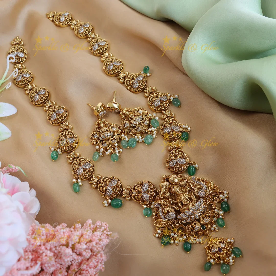 Elegant lakshmi and peacock design long necklace with cz stone - gold - Sparkle and Glow