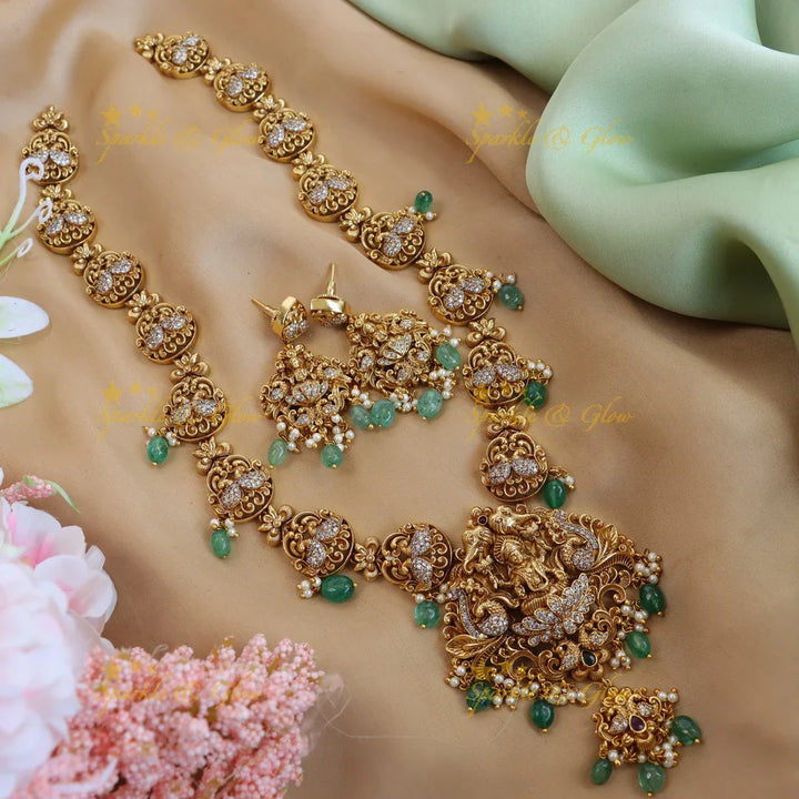 Elegant lakshmi and peacock design long necklace with cz stone - gold - Sparkle and Glow