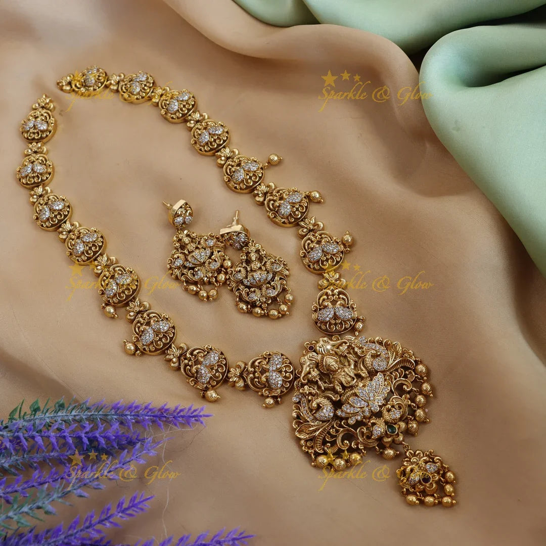 Elegant lakshmi and peacock design long necklace with cz stone - gold - Sparkle and Glow