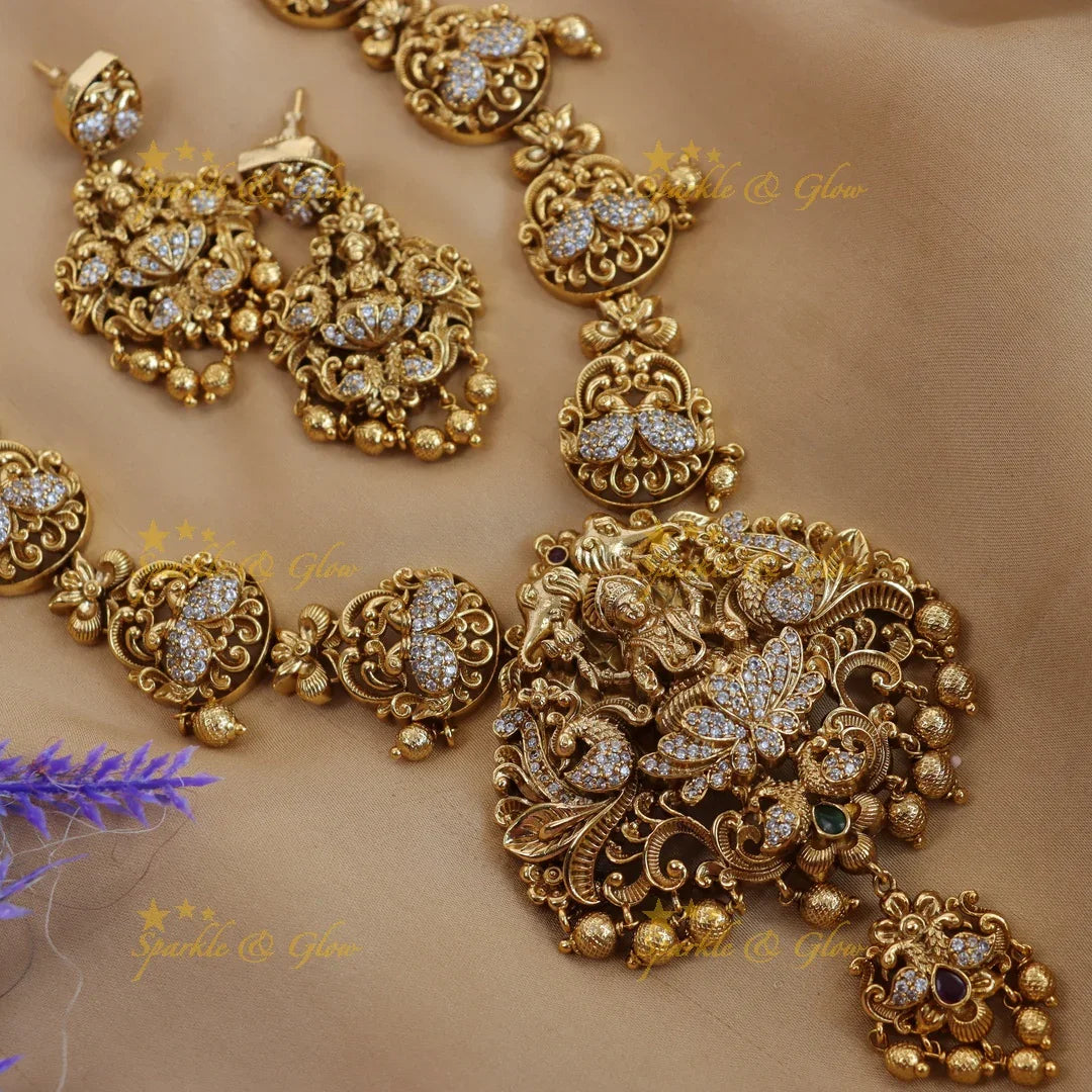 Elegant lakshmi and peacock design long necklace with cz stone - gold - Sparkle and Glow