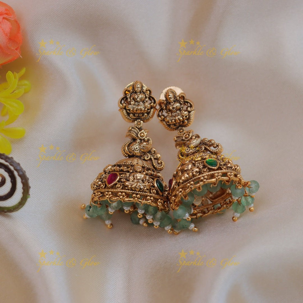 Grand lakshmi and peacock carved gold jumka - Mint green - Sparkle and Glow - Mint green - 