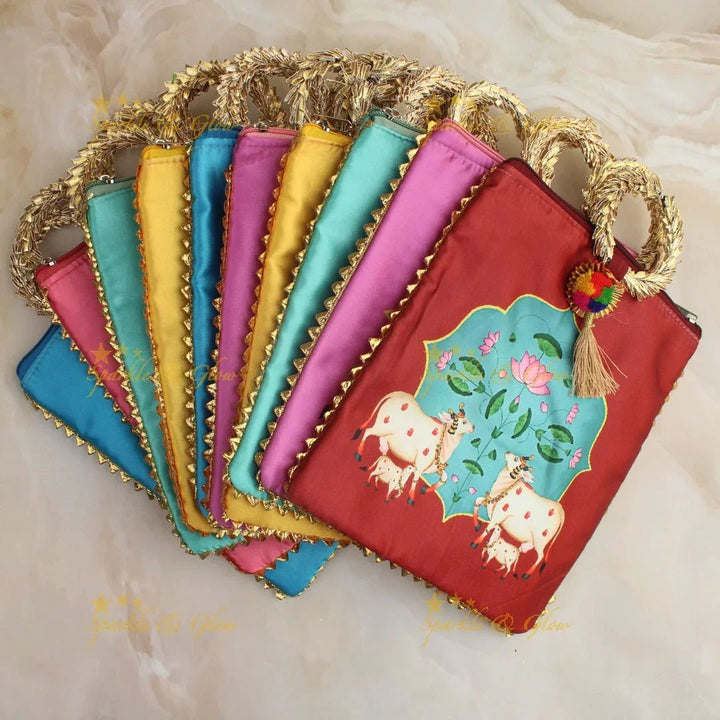 Beautiful cow printed potli bags - set of 10 - Assorted colours for return gifts - Sparkle and Glow