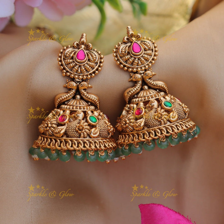 Grand peacock design gold jhumuka with jadau stone and mint green beads - Sparkle and Glow - 