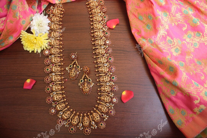 Gold alike polished lakshmi long necklace with flower studs made in real kemp stones