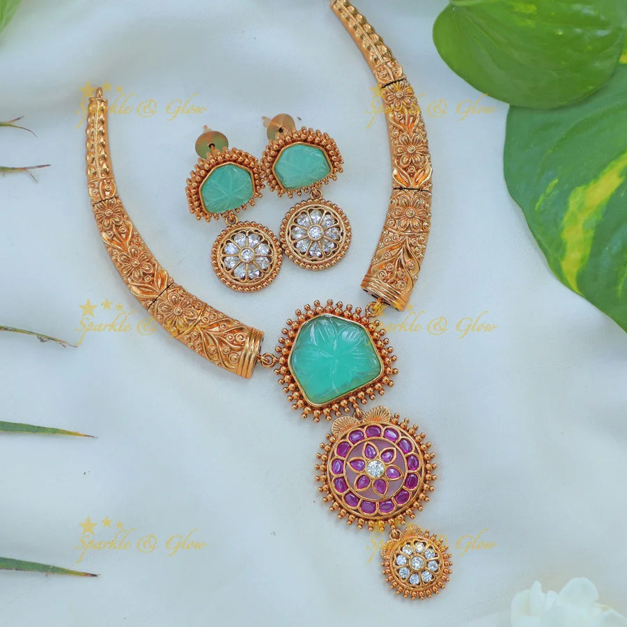 Beautiful Antique Gold alike Hasli Kanti Necklace Set with Green Stone & Floral Motif Pendants - Sparkle and Glow