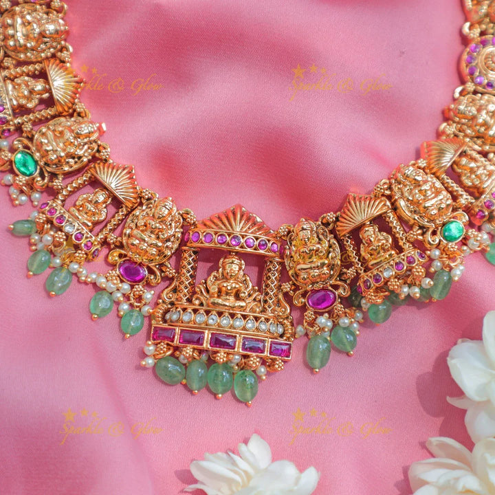 Stunning Antique gold alike Temple short necklace with Lakshmi Motifs and Green Beads - Sparkle and Glow