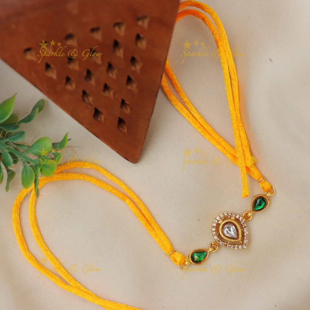 Regal Jadau Kundan Rakhi | Exquisite Green Stone Thread
