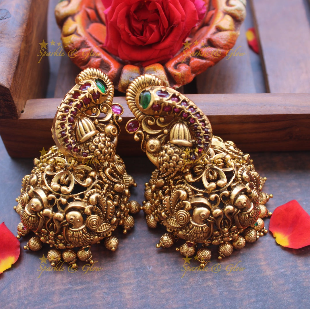 Gold alike peacock stud intricate jhumukas