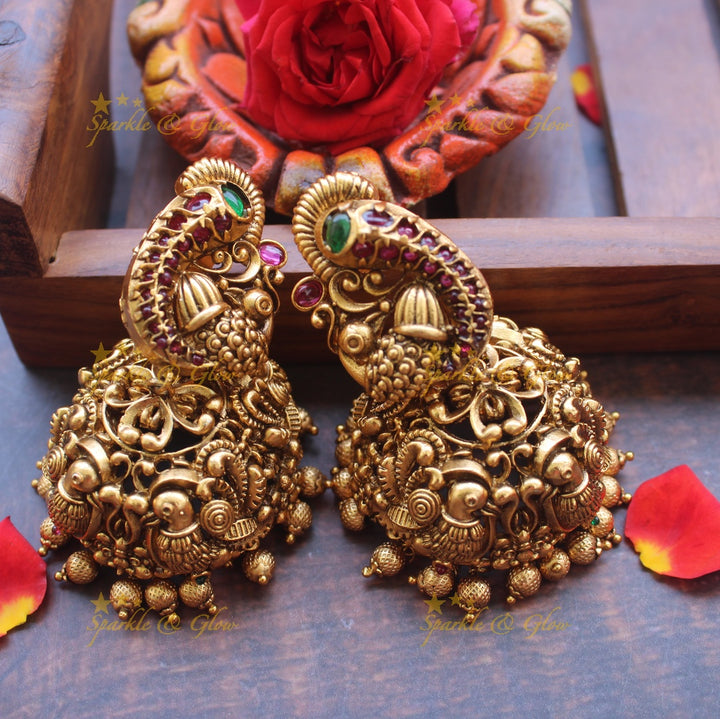 Gold alike peacock stud intricate jhumukas