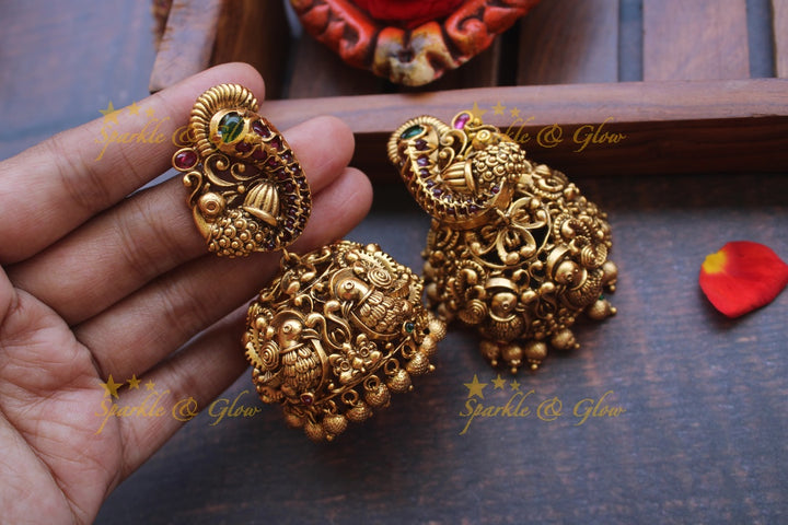 Gold alike peacock stud intricate jhumukas