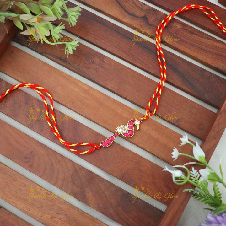 Exquisite Gold Polish Rakhi with Peacock Design