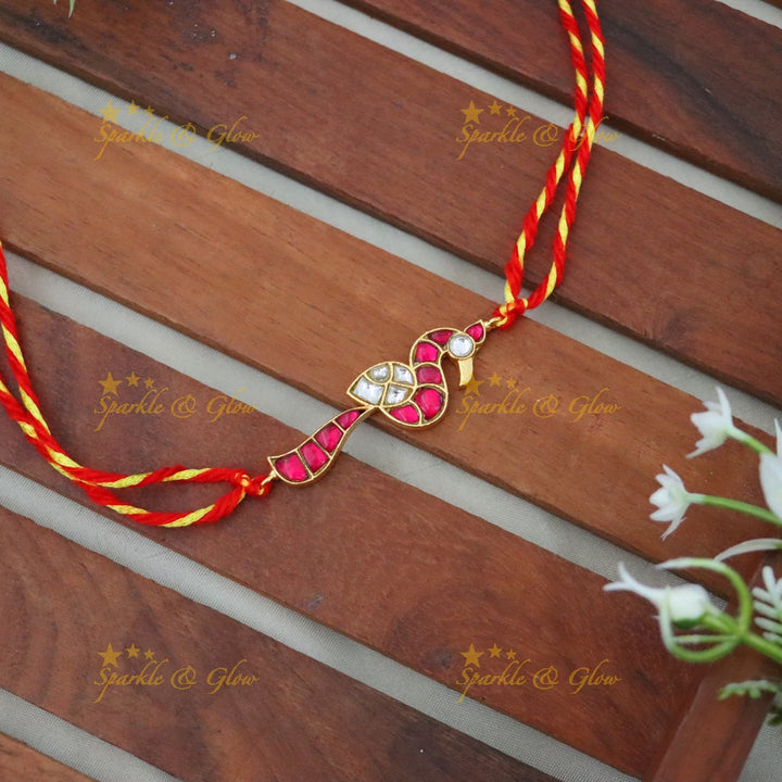 Exquisite Gold Polish Rakhi with Peacock Design