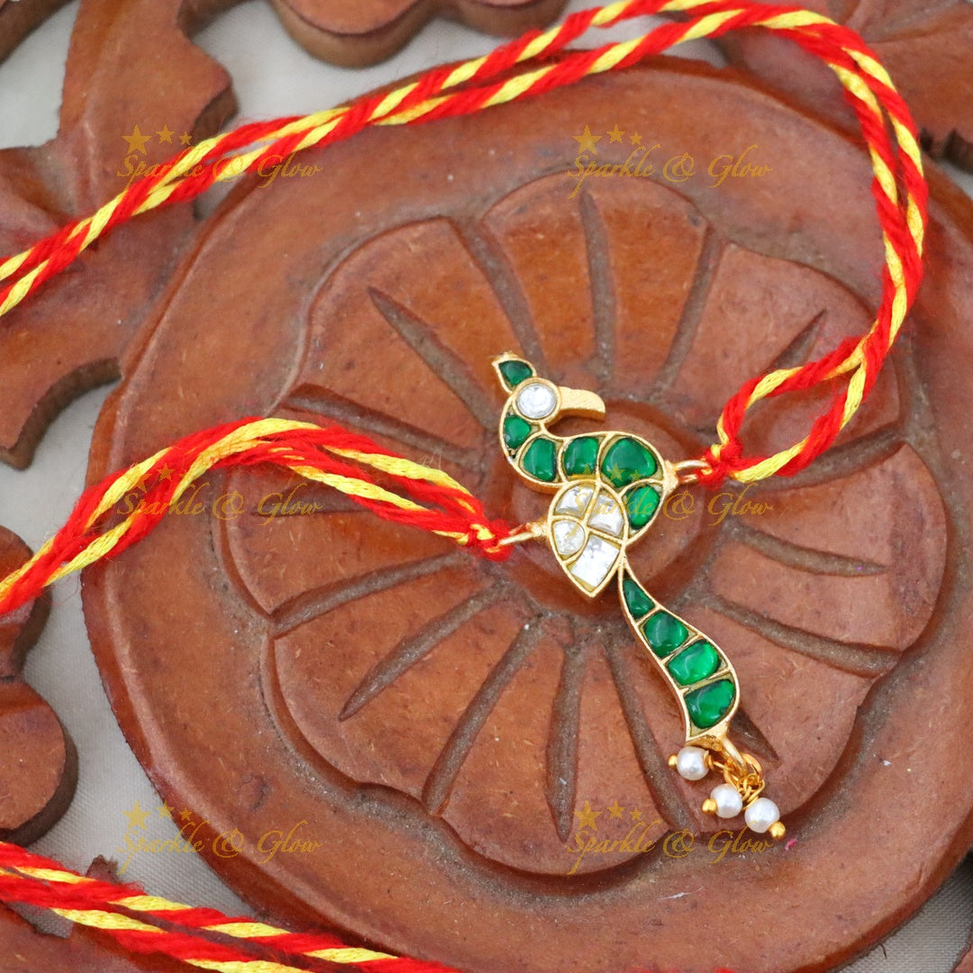 Exquisite Gold Polish Rakhi with Peacock Design