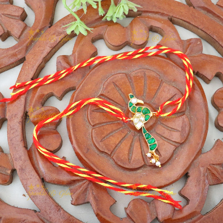 Exquisite Gold Polish Rakhi with Peacock Design