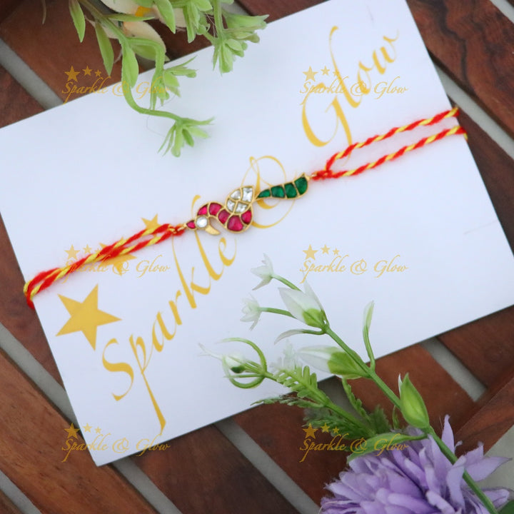 Exquisite Gold Polish Rakhi with Peacock Design