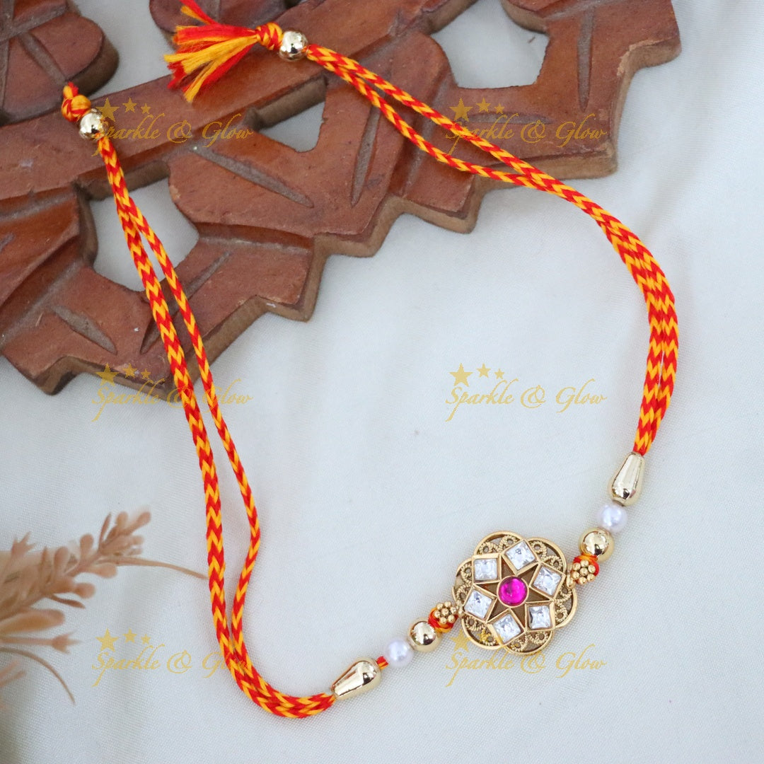 Elegant Rakhi with Gold and Red Threads