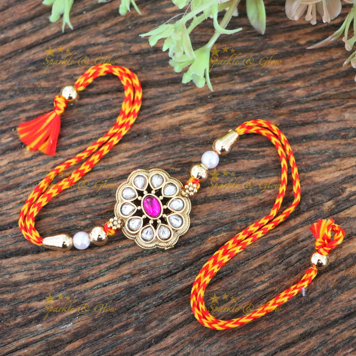 Elegant Rakhi with Gold Finish and Pearl Accents
