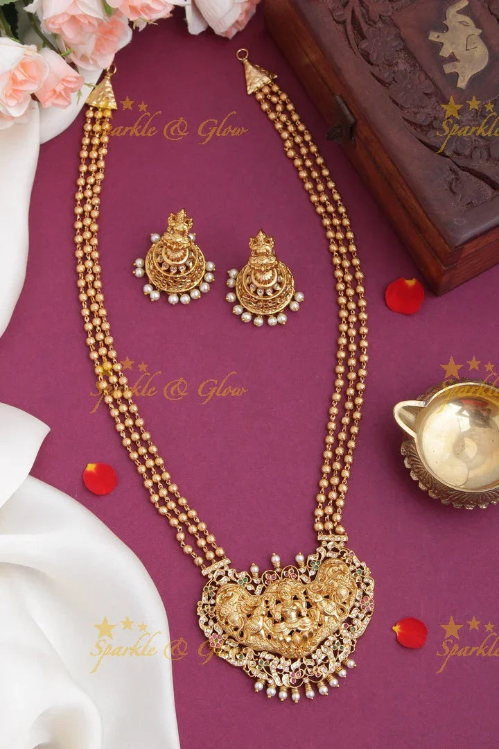 Layered gold beads with Intricately carved Lakshmi Peacock Elephant Pendent - Sparkle and Glow