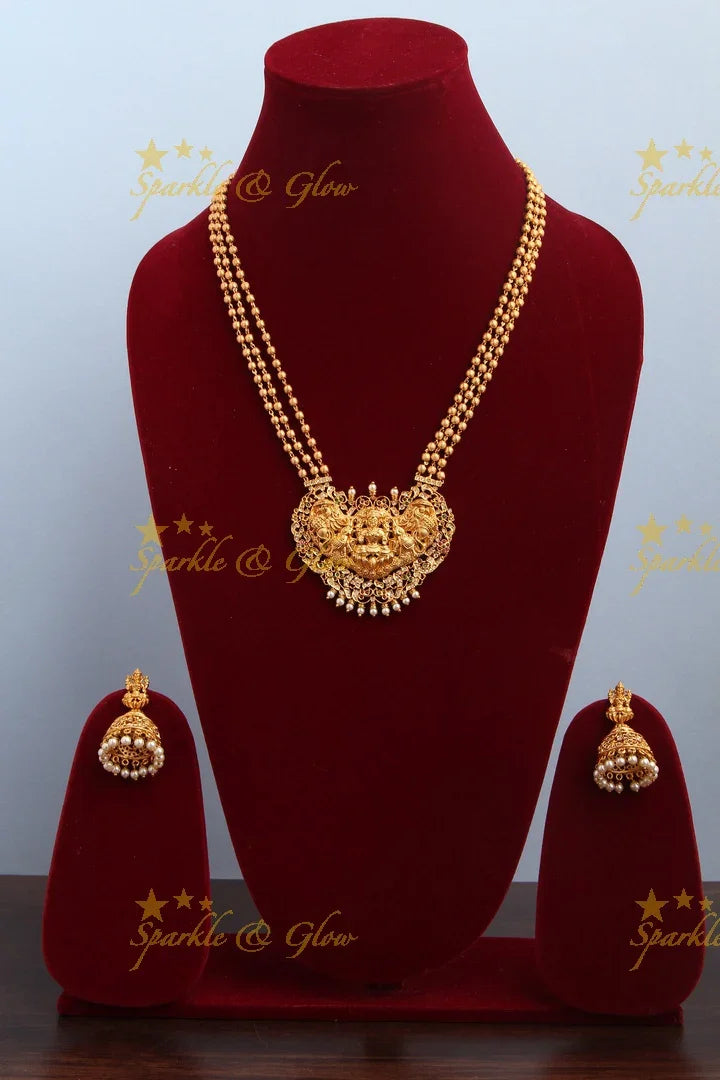 Layered gold beads with Intricately carved Lakshmi Peacock Elephant Pendent - Sparkle and Glow