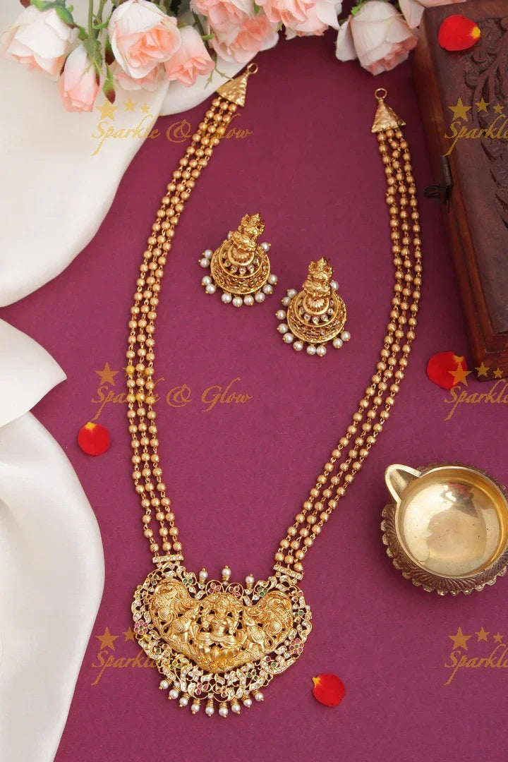 Layered gold beads with Intricately carved Lakshmi Peacock Elephant Pendent - Sparkle and Glow