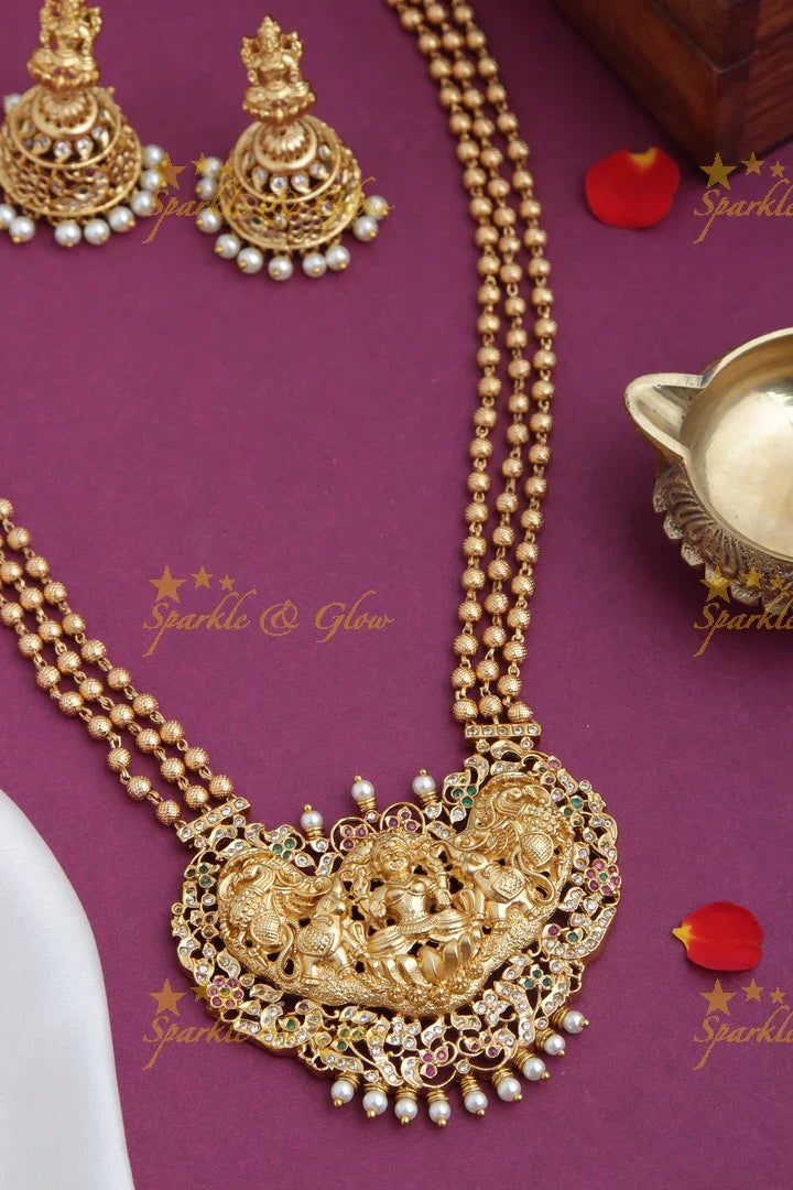 Layered gold beads with Intricately carved Lakshmi Peacock Elephant Pendent - Sparkle and Glow
